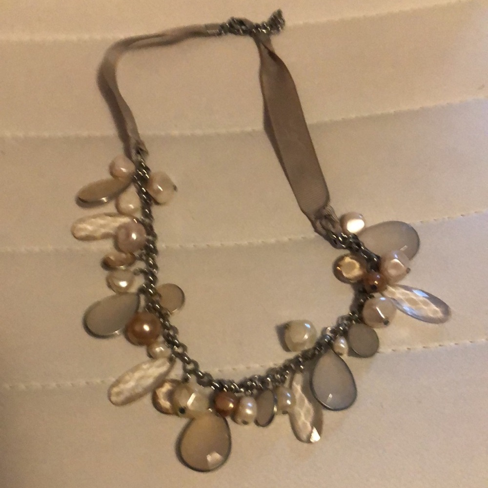 Beaded necklace tan, clear and white beads. Can adjust length some